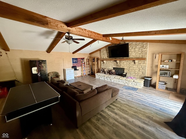 910 Ranch Rd, Connersville, IN 47331 - living room with wood finished floors, ceiling fan, a textured ceiling, and a fireplace