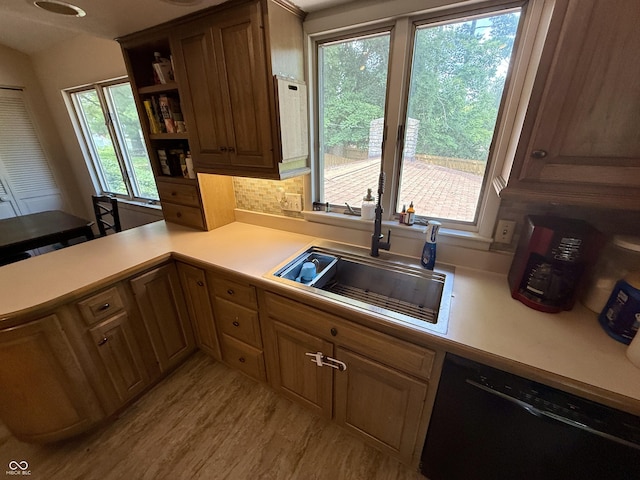 910 Ranch Rd, Connersville, IN 47331 - kitchen with black dishwasher, light countertops, light wood-style floors, a peninsula, and open shelves