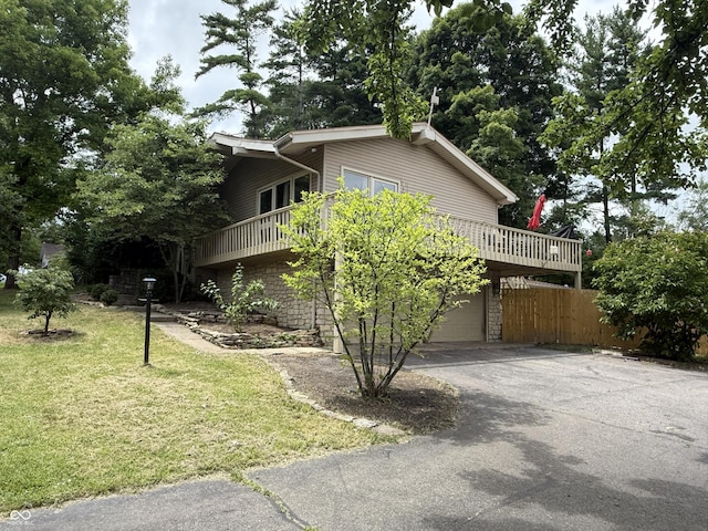 910 Ranch Rd, Connersville, IN 47331 - view of side of property with asphalt driveway, a garage, and a wooden deck