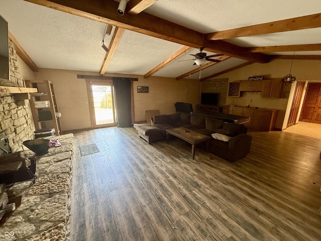 910 Ranch Rd, Connersville, IN 47331 - living room with wood finished floors, ceiling fan, a large fireplace, and a textured ceiling