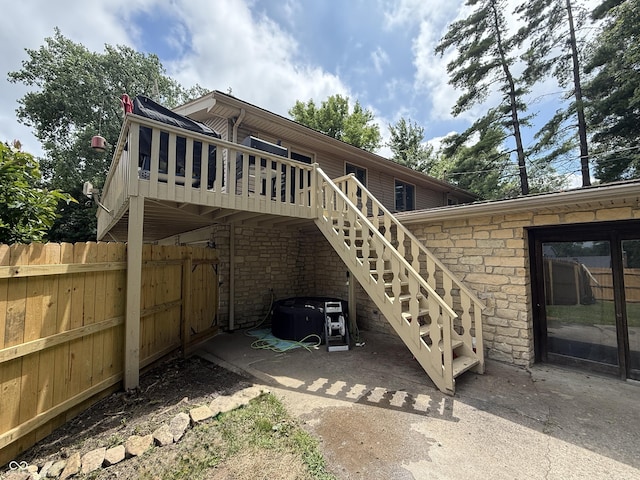 910 Ranch Rd, Connersville, IN 47331 - rear view of house featuring stone siding, a wooden deck, and stairs