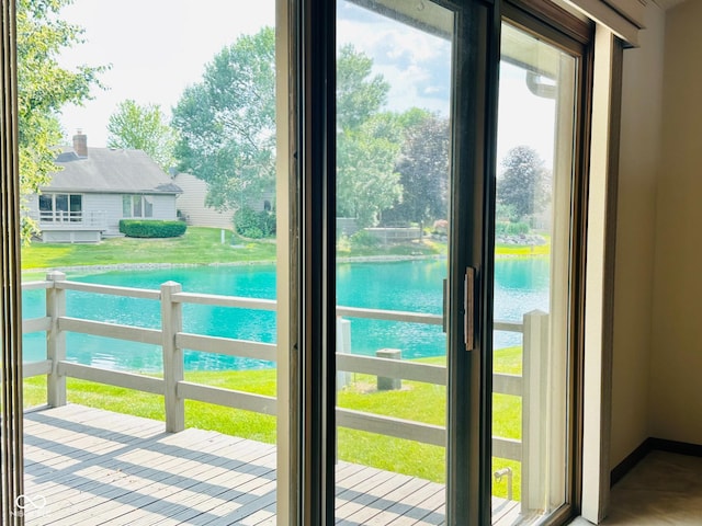 5720 Bayside Dr, Fort Wayne, IN 46815 - doorway to outside with plenty of natural light, a water view, and view of wooded area