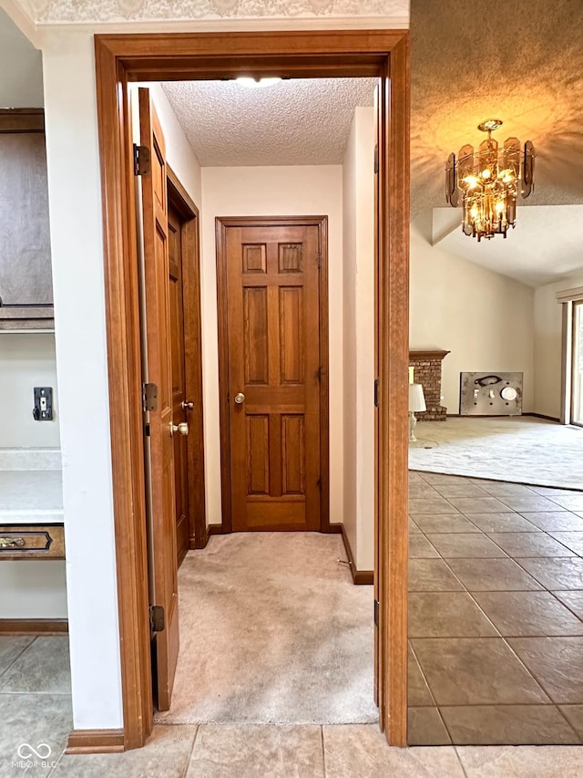 5720 Bayside Dr, Fort Wayne, IN 46815 - hall featuring a chandelier and a textured ceiling