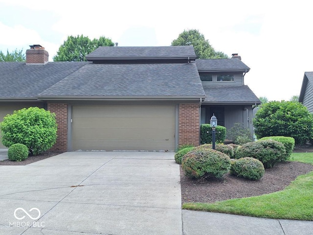 5720 Bayside Dr, Fort Wayne, IN 46815 - view of front of property featuring a chimney, a garage, concrete driveway, and brick siding