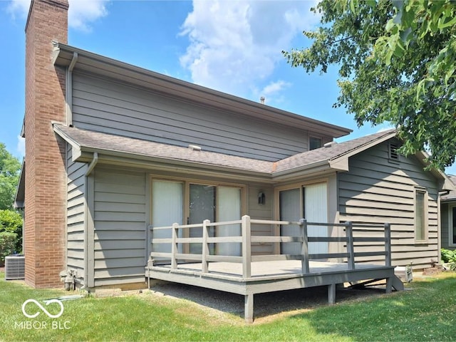 5720 Bayside Dr, Fort Wayne, IN 46815 - back of property featuring a chimney, a deck, a yard, and roof with shingles