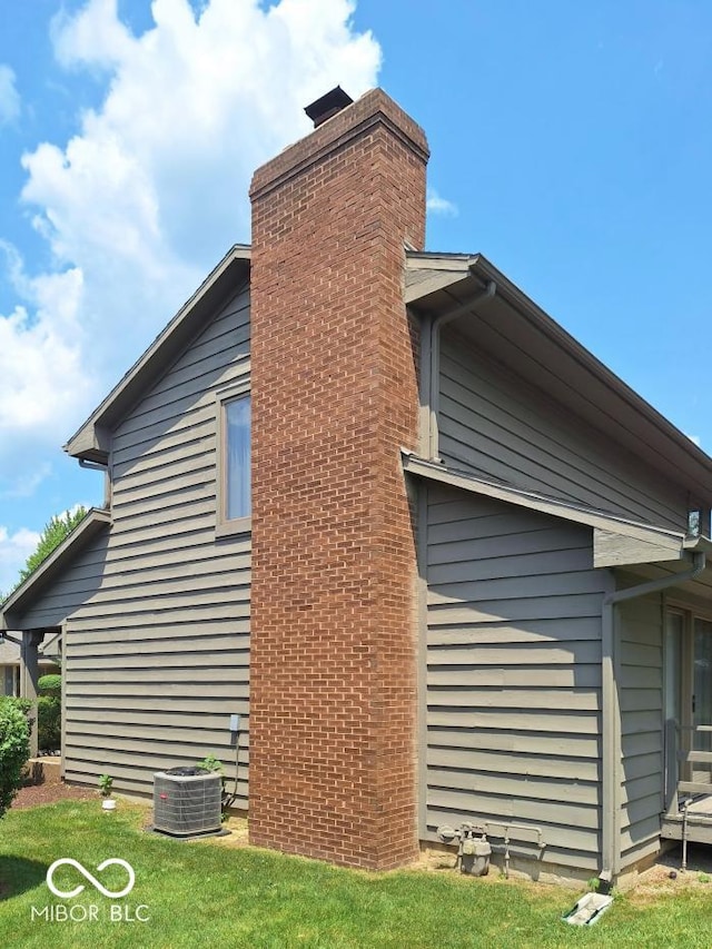 5720 Bayside Dr, Fort Wayne, IN 46815 - view of side of home with a chimney and a lawn