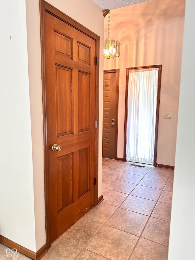 5720 Bayside Dr, Fort Wayne, IN 46815 - entryway with a chandelier and light tile patterned floors