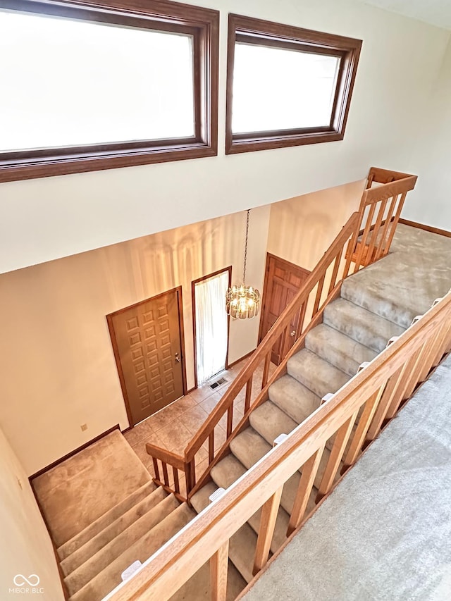 5720 Bayside Dr, Fort Wayne, IN 46815 - staircase with healthy amount of natural light, carpet floors, and a high ceiling