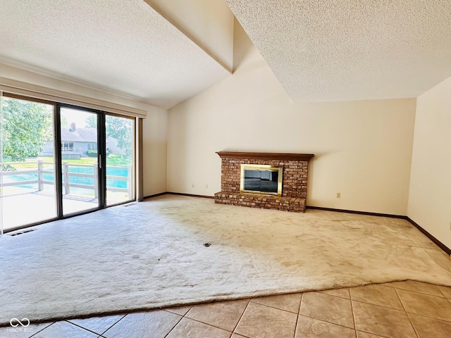 5720 Bayside Dr, Fort Wayne, IN 46815 - unfurnished living room featuring carpet floors, a textured ceiling, lofted ceiling, tile patterned flooring, and a brick fireplace