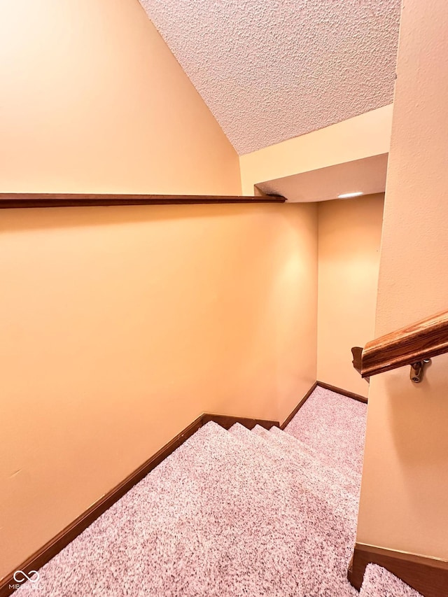 5720 Bayside Dr, Fort Wayne, IN 46815 - staircase with carpet flooring, a textured ceiling, and lofted ceiling