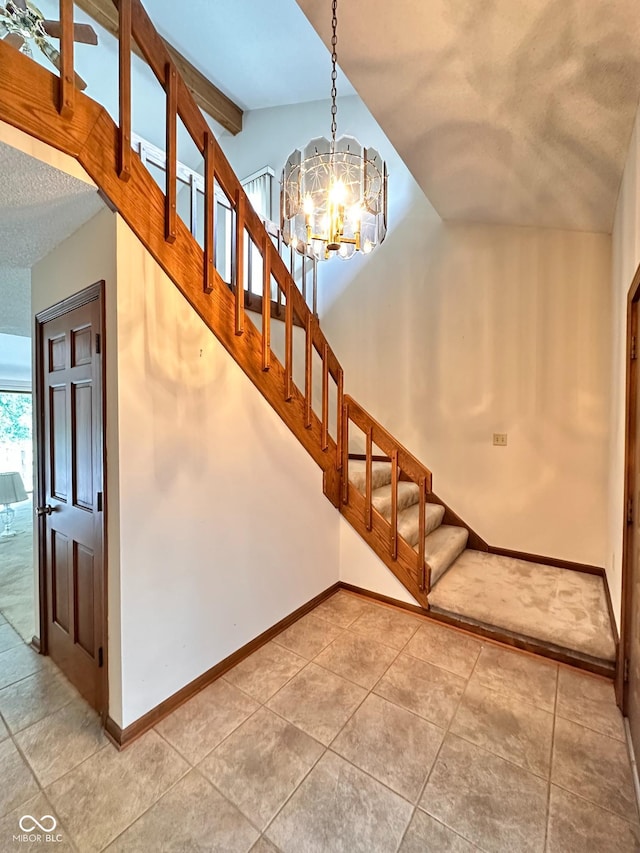 5720 Bayside Dr, Fort Wayne, IN 46815 - staircase with a chandelier, vaulted ceiling, and tile patterned floors