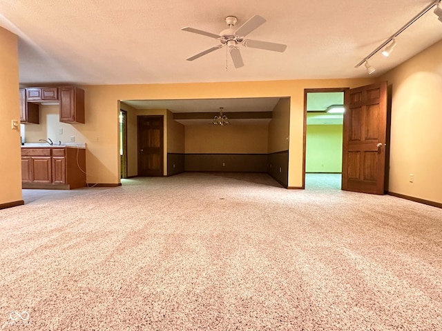 5720 Bayside Dr, Fort Wayne, IN 46815 - unfurnished living room featuring a ceiling fan, light colored carpet, a chandelier, and rail lighting
