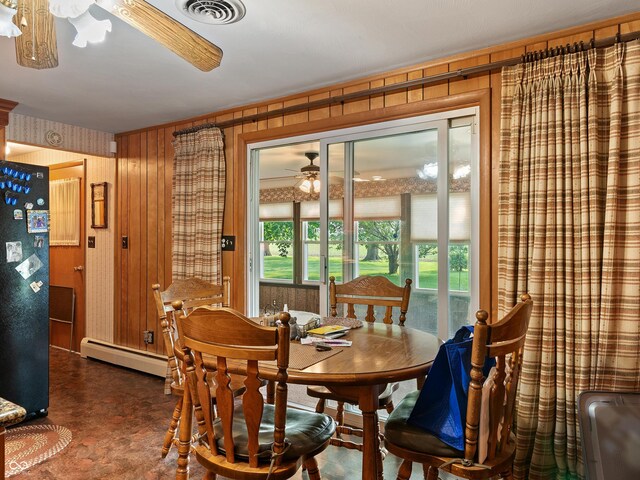 2601 N Everett St, Crawfordsville, IN 47933 - dining room featuring a ceiling fan, a baseboard radiator, and wooden walls