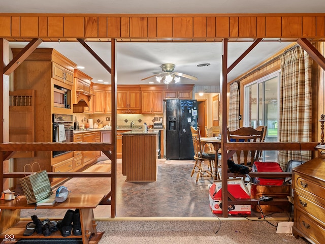 2601 N Everett St, Crawfordsville, IN 47933 - kitchen featuring black appliances, a ceiling fan, a center island, and brown cabinets