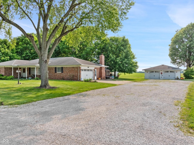 2601 N Everett St, Crawfordsville, IN 47933 - single story home featuring driveway, a chimney, an attached garage, a front yard, and brick siding