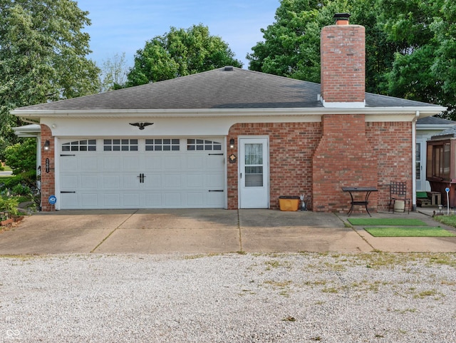 2601 N Everett St, Crawfordsville, IN 47933 - view of front facade with a chimney, brick siding, a garage, and roof with shingles