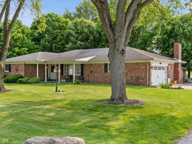 2601 N Everett St, Crawfordsville, IN 47933 - ranch-style house featuring a garage, a front yard, a chimney, brick siding, and concrete driveway