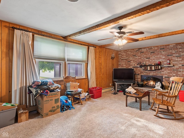 2601 N Everett St, Crawfordsville, IN 47933 - living room featuring carpet floors, beam ceiling, a baseboard radiator, a ceiling fan, and wooden walls