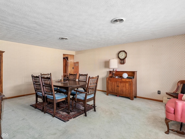 2601 N Everett St, Crawfordsville, IN 47933 - dining room with carpet floors, a textured ceiling, wallpapered walls, and baseboard heating