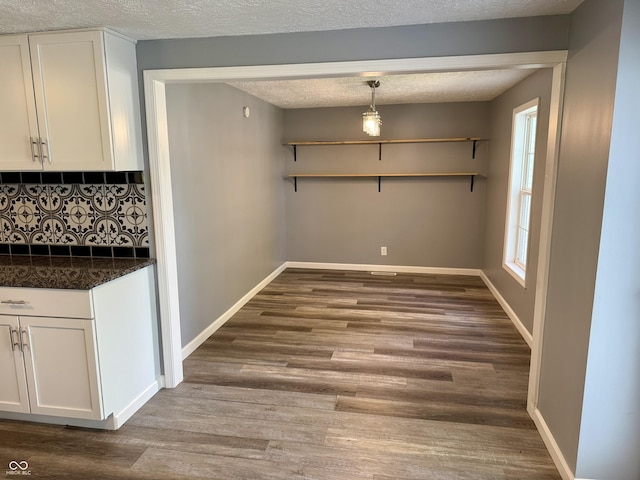 4833 Pennsylvania St, Clayton, IN 46118 - unfurnished dining area featuring wood finished floors and a textured ceiling