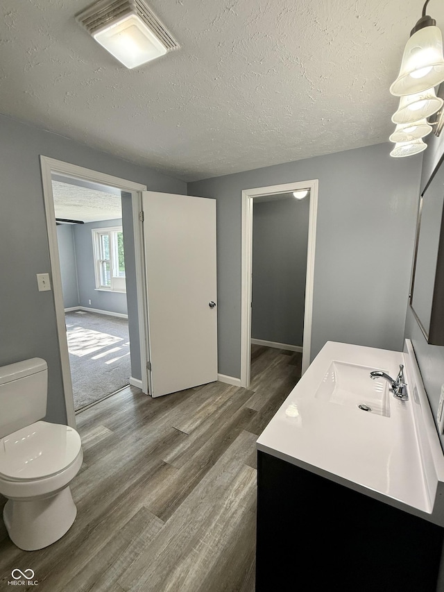 4833 Pennsylvania St, Clayton, IN 46118 - bathroom featuring vanity, wood finished floors, and a textured ceiling