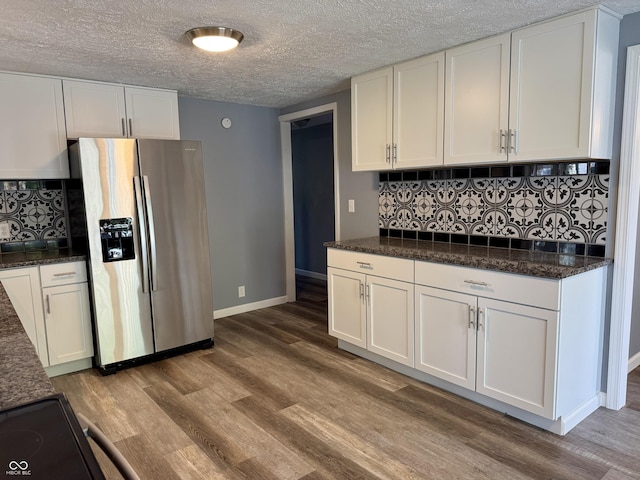 4833 Pennsylvania St, Clayton, IN 46118 - kitchen with stainless steel fridge, white cabinets, wood finished floors, decorative backsplash, and a textured ceiling