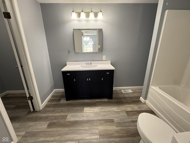 4833 Pennsylvania St, Clayton, IN 46118 - full bathroom with vanity, wood finished floors, and bathtub / shower combination