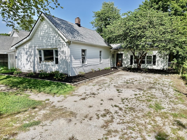4833 Pennsylvania St, Clayton, IN 46118 - view of front facade featuring a chimney and brick siding