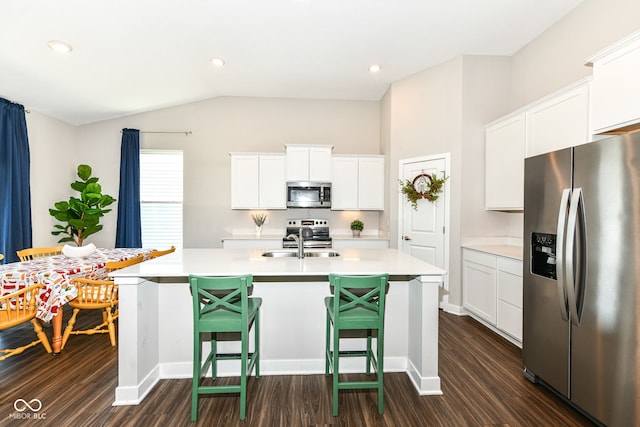 9846 Zion Way, Pendleton, IN 46064 - kitchen with stainless steel appliances, light countertops, a kitchen island with sink, dark wood-style floors, and vaulted ceiling
