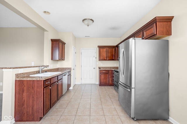 3827 Dusty Sands Rd, Whitestown, IN 46075 - kitchen with appliances with stainless steel finishes, a peninsula, light tile patterned flooring, and light stone counters