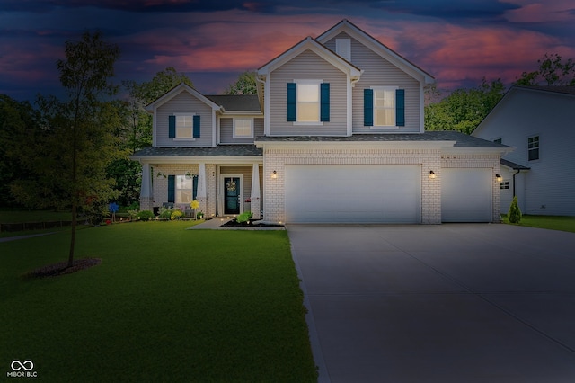 17977 Ambrosia Trl, Westfield, IN 46074 - view of front of property with concrete driveway, a garage, a front lawn, brick siding, and a shingled roof