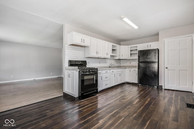 1701 N Gladstone Ave, Indianapolis, IN 46218 - kitchen featuring black appliances, dark wood-type flooring, white cabinets, and backsplash