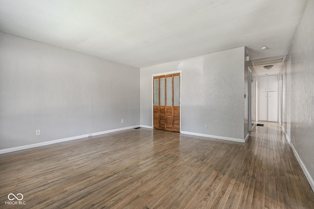 1701 N Gladstone Ave, Indianapolis, IN 46218 - spare room with wood finished floors and attic access