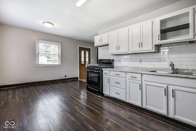 1701 N Gladstone Ave, Indianapolis, IN 46218 - kitchen featuring gas stove, tasteful backsplash, white cabinets, dark wood-style flooring, and glass insert cabinets