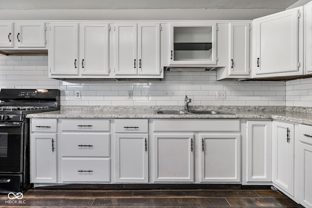 1701 N Gladstone Ave, Indianapolis, IN 46218 - kitchen featuring black gas stove, white cabinetry, decorative backsplash, and light stone counters