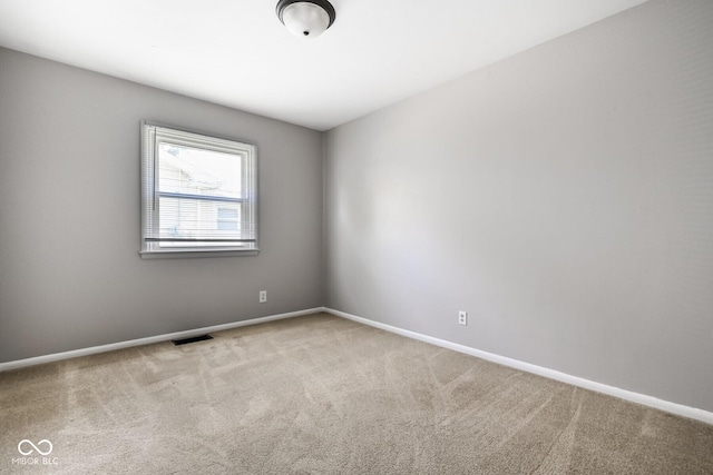 1701 N Gladstone Ave, Indianapolis, IN 46218 - carpeted empty room with baseboards
