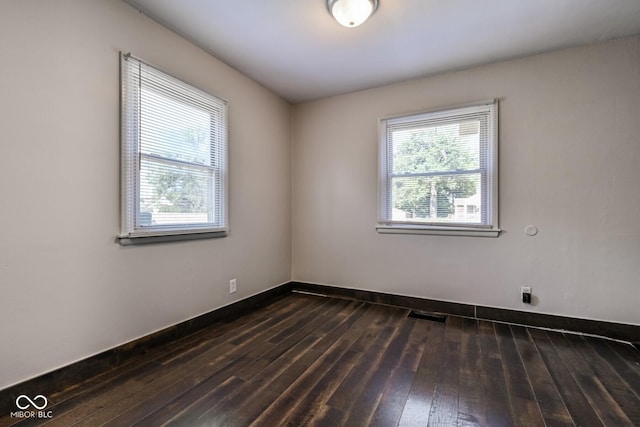 1701 N Gladstone Ave, Indianapolis, IN 46218 - spare room with dark wood-type flooring and baseboards