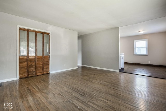 1701 N Gladstone Ave, Indianapolis, IN 46218 - spare room with dark wood-type flooring and baseboards