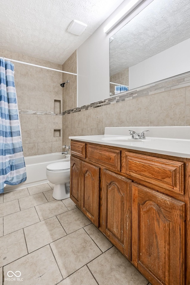 1701 N Gladstone Ave, Indianapolis, IN 46218 - full bath featuring shower / bath combo with shower curtain, a textured ceiling, tile walls, vanity, and tile patterned flooring