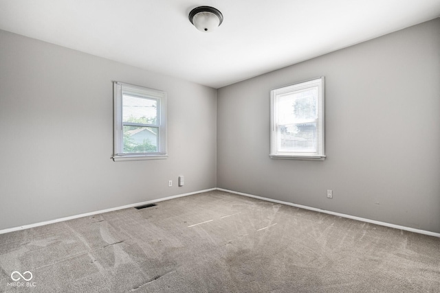 1701 N Gladstone Ave, Indianapolis, IN 46218 - spare room with carpet floors and baseboards