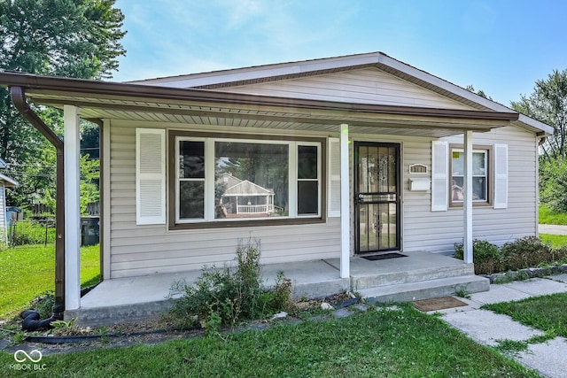 1701 N Gladstone Ave, Indianapolis, IN 46218 - view of front of house with a porch and a front lawn