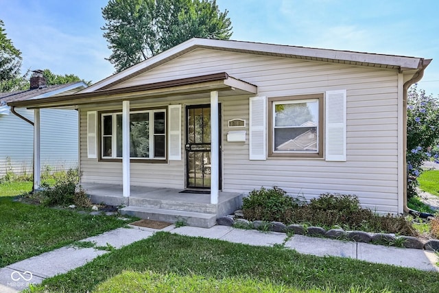 1701 N Gladstone Ave, Indianapolis, IN 46218 - view of front of home featuring a porch and a front lawn