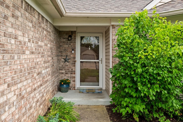 49 Grassy Dr, Whiteland, IN 46184 - property entrance with a shingled roof and brick siding