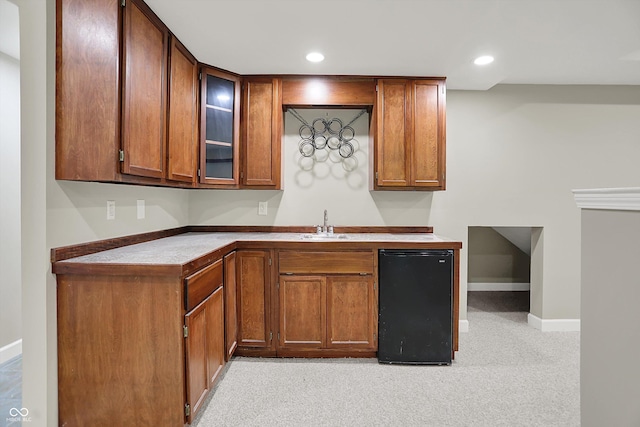7131 Nile Ridge Ct, Indianapolis, IN 46236 - kitchen with refrigerator, glass insert cabinets, brown cabinetry, recessed lighting, and light colored carpet