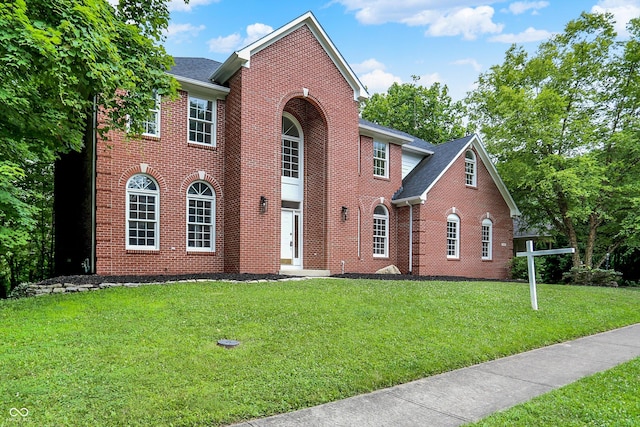7131 Nile Ridge Ct, Indianapolis, IN 46236 - view of front of home with brick siding, a front lawn, and roof with shingles
