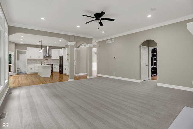 7131 Nile Ridge Ct, Indianapolis, IN 46236 - unfurnished living room with ornamental molding, ceiling fan, arched walkways, recessed lighting, and decorative columns