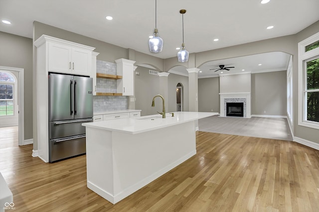 7131 Nile Ridge Ct, Indianapolis, IN 46236 - kitchen with high end refrigerator, a ceiling fan, light wood-style flooring, light countertops, and white cabinets