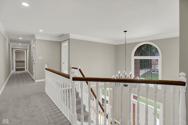 7131 Nile Ridge Ct, Indianapolis, IN 46236 - hall featuring a chandelier, an upstairs landing, ornamental molding, light colored carpet, and recessed lighting