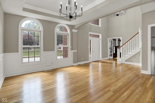 7131 Nile Ridge Ct, Indianapolis, IN 46236 - foyer featuring a chandelier, light wood finished floors, healthy amount of natural light, and crown molding