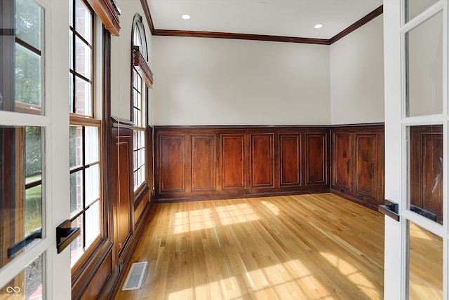7131 Nile Ridge Ct, Indianapolis, IN 46236 - spare room with ornamental molding, light wood-style flooring, healthy amount of natural light, and a wainscoted wall